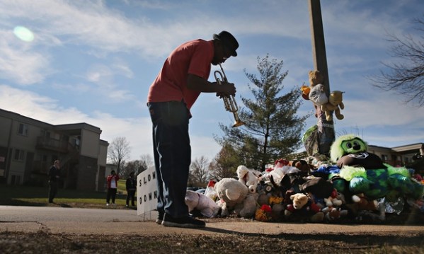 Pastor Eugene Gillis playing his trumpet at Michael Brown's memorial