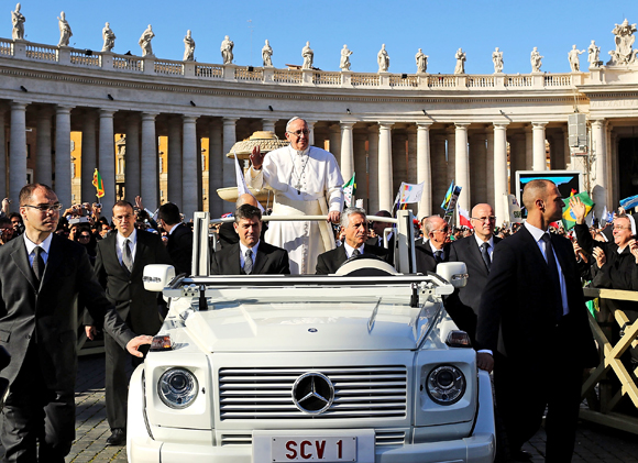 VATICAN CITY, VATICAN - MARCH 19: Pope Francis drives through the crowds during the Inauguration Mass for the Pope in St Peter's Square on March 19, 2013 in Vatican City, Vatican. The mass is being held in front of an expected crowd of up to one million pilgrims and faithful who have filled the square and the surrounding streets to see the former Cardinal of Buenos Aires officially take up his role as pontiff. (Photo by Spencer Platt/Getty Images)