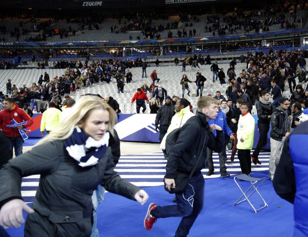 Spectators invade the pitch of the Stade de France stadium after the international friendly soccer match. Friday, Nov. 13, 2015. Explosions were heard nearby. Photo/Christophe Ena)