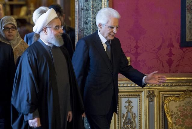 Iran's President Hassan Rouhani (L) walks next to his Italian counterpart President Sergio Mattarella 