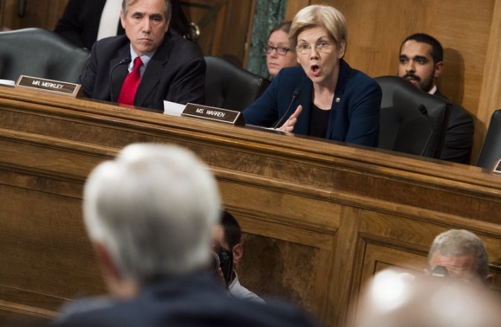 Sen. Elizabeth Warren questions John Stumpf, chairman and CEO of Wells Fargo, about the unauthorized opening of customer accounts by Wells Fargo during a Senate Banking Committee hearing Tuesday. Saul Loeb/AFP/Getty Images